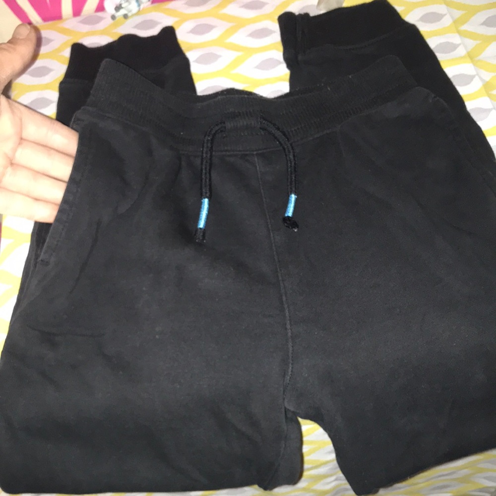 Navy blue sweatpants with pockets and drawstring.